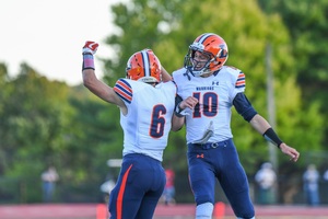 Cade Clouthier (No. 6) and Alex Ruston (No. 10) celebrate after one of Clouthier's three touchdowns in Liverpool's win. 