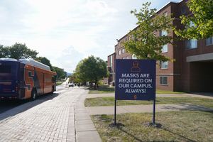 The university is encouraging students to wash their hands rather than use disposable gloves and wear reusable masks when possible.
