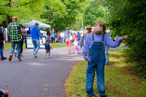 A scarecrow welcomes families at the entrance of the Golden Harvest Festival. Scarecrows were randomly planted across the event and depicted a specific theme highlighted in each of their areas.