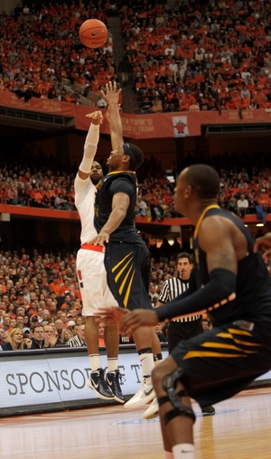 James Southerland shoots as Kevin Jones contests in Syracuse's 63-61 win over WVU on Saturday.