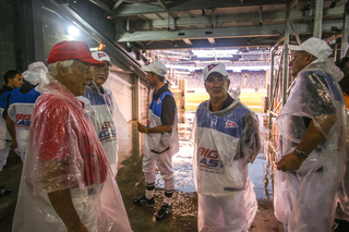 Big East officials wait inside the stadium during a weather delay due to lightning.