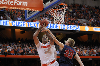 Syracuse center DaJuan Coleman attempts a layup.