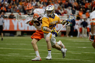 Paolo Ciferri defends an Albany player racing toward the cage. 