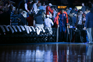 Injured Syracuse center DaJuan Coleman enters the court on crutches. 