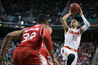 Ennis shoots off one foot with Washington nearby. 