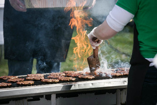 Kitchen cooks prepare hamburgers for students. Burgers, corn dogs and other  snacks were given to students for free.