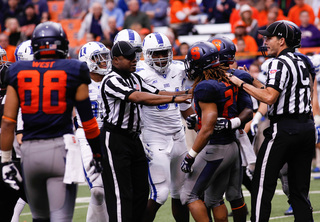 Referrees attempt to stop an argument between Duke and Syracuse.