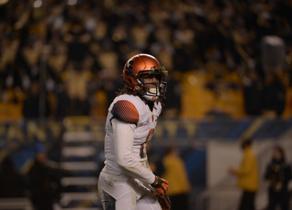 Ishamel adjusts his left glove with a chunk on turf stuck in his helmet. The freshman had six catches for 97 yards.