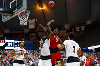 Abu fights for a loose ball against a trio of Cardinals late in the first half. 