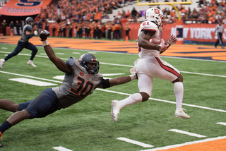 Linebacker Parris Bennett extends his left arm to try to make a play on N.C. State's Matthew Dayes.