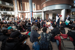 Dina Eldawy Syracuse University Muslim Student Association Co-President, uses a megaphone to speak about how people can help refugees in the Syracuse community during a protest on the campus of Syracuse University. 