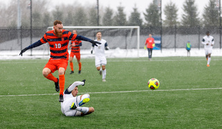 Delhommelle leaps over an Akron defender.