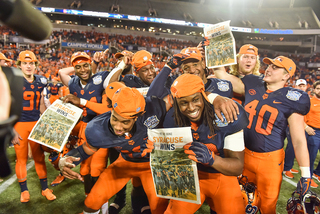 SU players hold newspapers headlined 