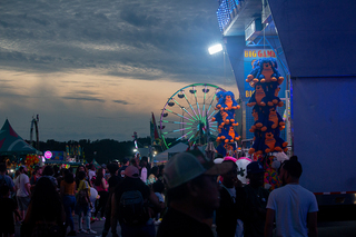 People crowd around one of the many carnival games at the New York State Fair. 