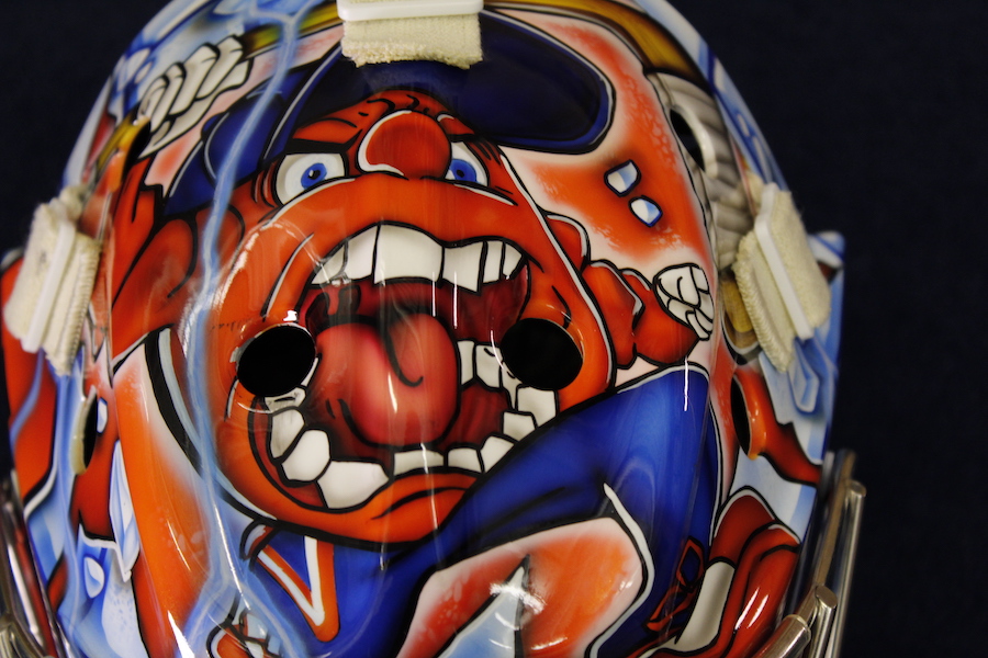 Allison Small's mask from above focused on a depiction of Otto the Orange.